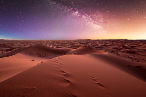 Amazing milky way over the dunes Erg Chebbi in the Sahara desert near Merzouga, Morocco , Africa. Beautiful sand landscape with stunning sky full of stars and night under a starry sky. After sunset.