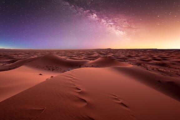 Amazing milky way over the dunes Erg Chebbi in the Sahara desert near Merzouga, Morocco , Africa. Beautiful sand landscape with stunning sky full of stars and night under a starry sky. After sunset. Amazing milky way over the dunes Erg Chebbi in the Sahara desert near Merzouga, Morocco , Africa. Beautiful sand landscape with stunning sky full of stars and night under a starry sky. After sunset.