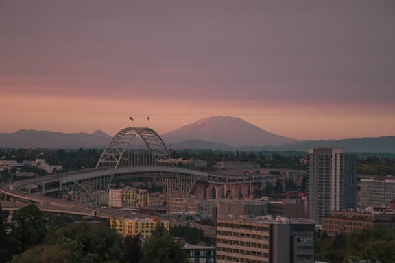 Mount Saint Helens looms in the background behind Fremont Bridge in the city of Portland, Oregon.