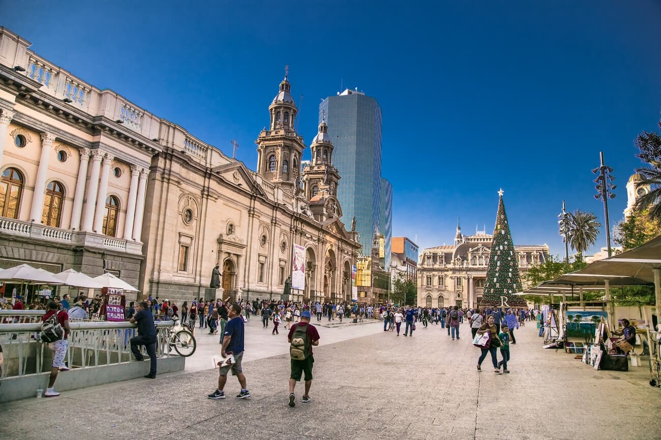 People commute in the Plaza de Armas square in Santiago