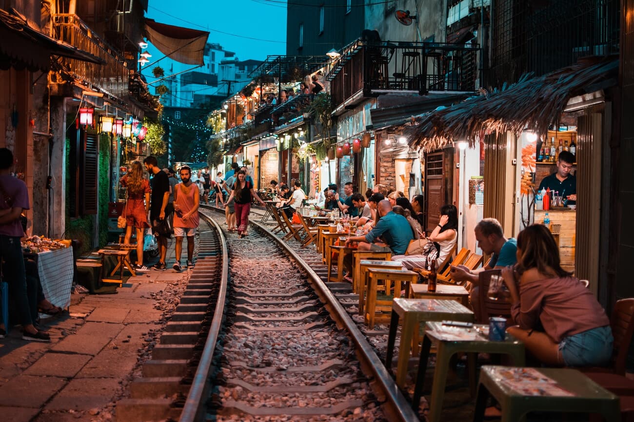 Train street filled with shops, restaurants, and cafes in Hanoi's Old Quarter