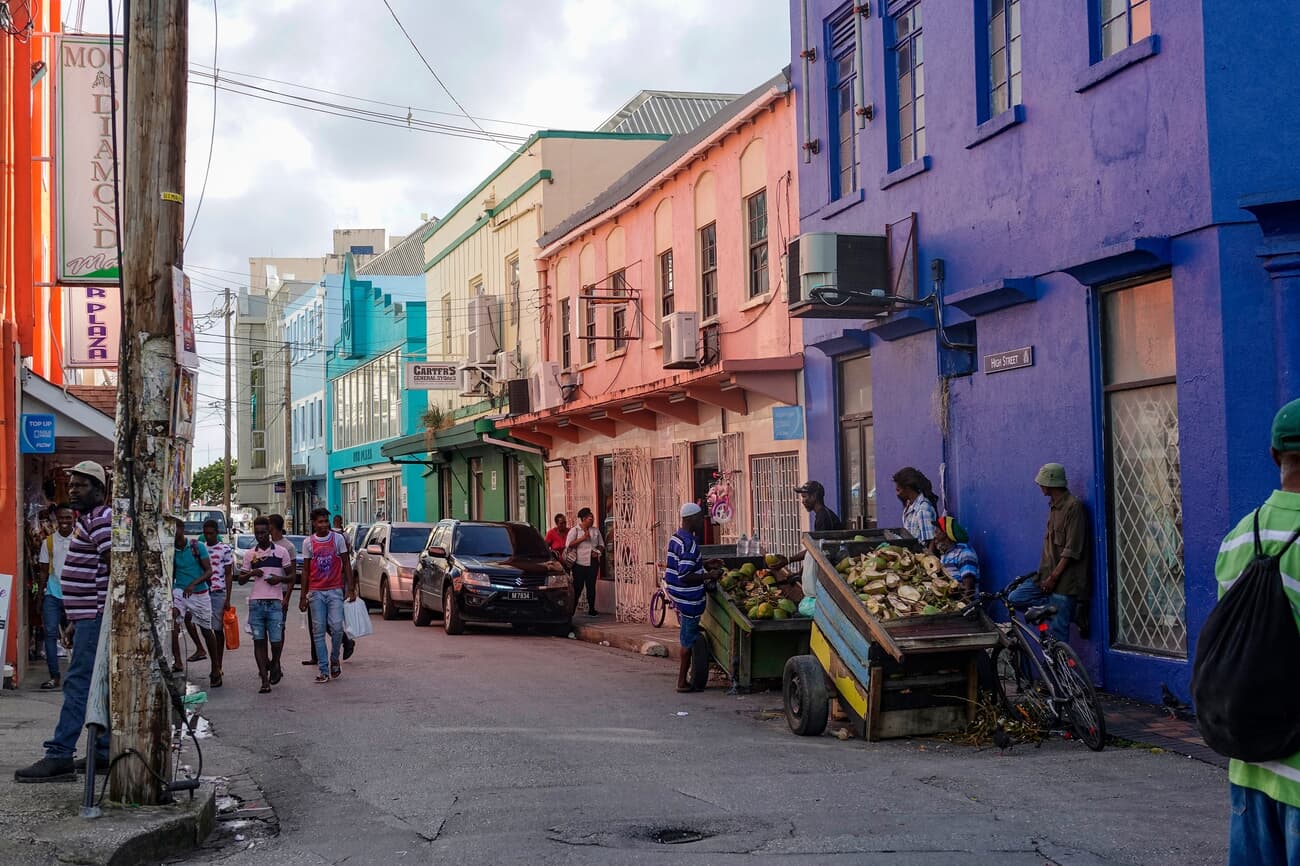 Locals commute through the busy streets lined with colorful houses