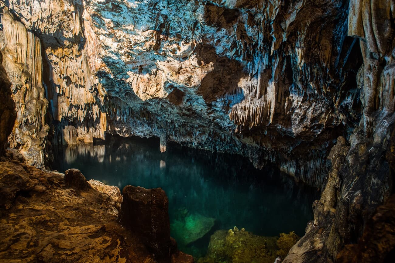 Anahulu Cave, featuring stunning limestone formations and an underground pool