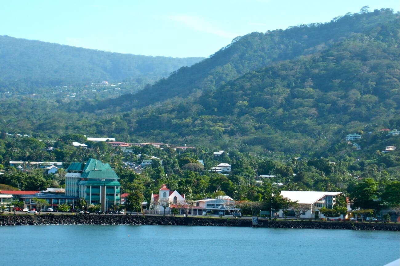The cityscape of Apia, a bustling urban center set against verdant hills and the Pacific Ocean