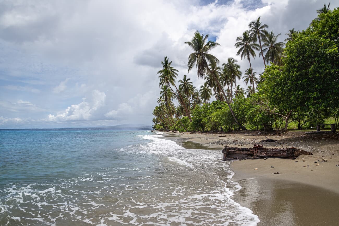 Mbonege Beach, known for its crystal-clear waters and historical remnants from WWII