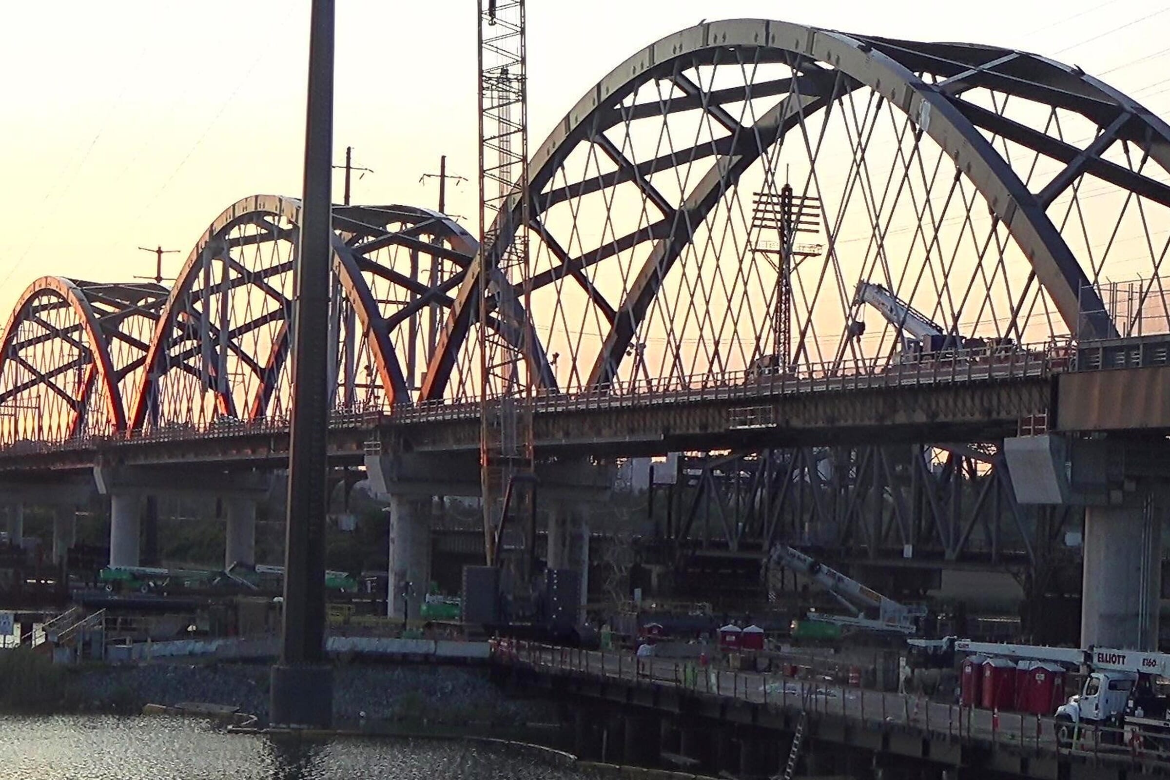 Portal North Bridge arch spans over the Hackensack River at sunset, June 2025