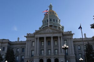 Colorado State Capitol gold dome under blue sky — a symbol of state government, which administers most public pension plans in the US.