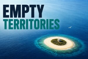 A tiny remote uninhabited island alone in the ocean, representing the world’s empty territories