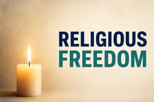 A single lit candle, symbolising faith and religious freedom under pressure