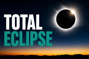 A total solar eclipse with the Sun's corona around a black Moon, over a twilight sunset horizon